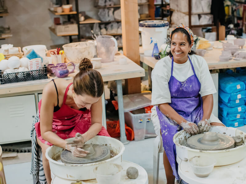 people smiling at wheel throwing class